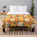 Colorful yellow and white daisy floral pattern on a plush blanket