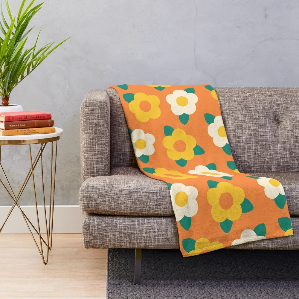 Colorful yellow and white daisy floral pattern on a plush blanket