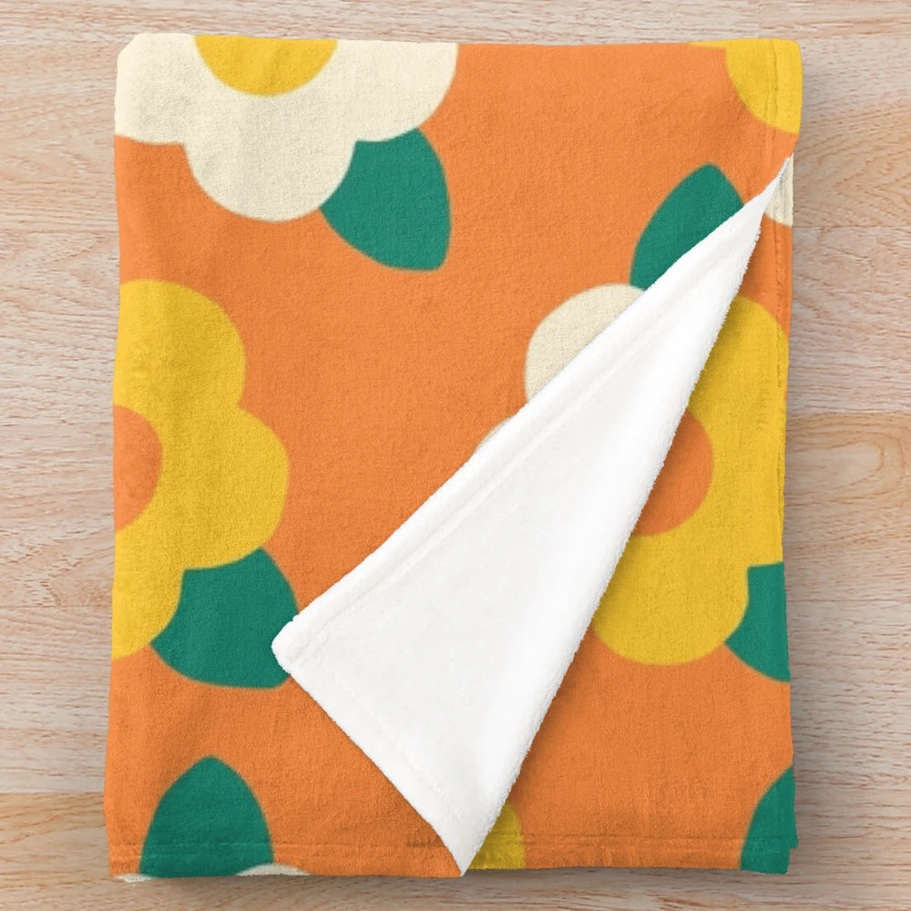 Colorful yellow and white daisy floral pattern on a plush blanket