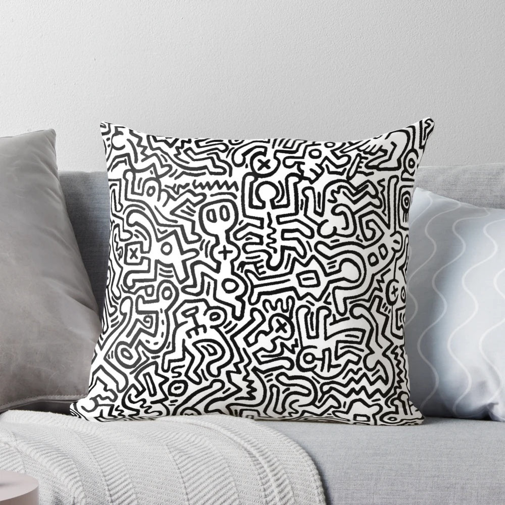 A black and white pillow with abstract dancing figures, evoking a modern, artistic aesthetic.