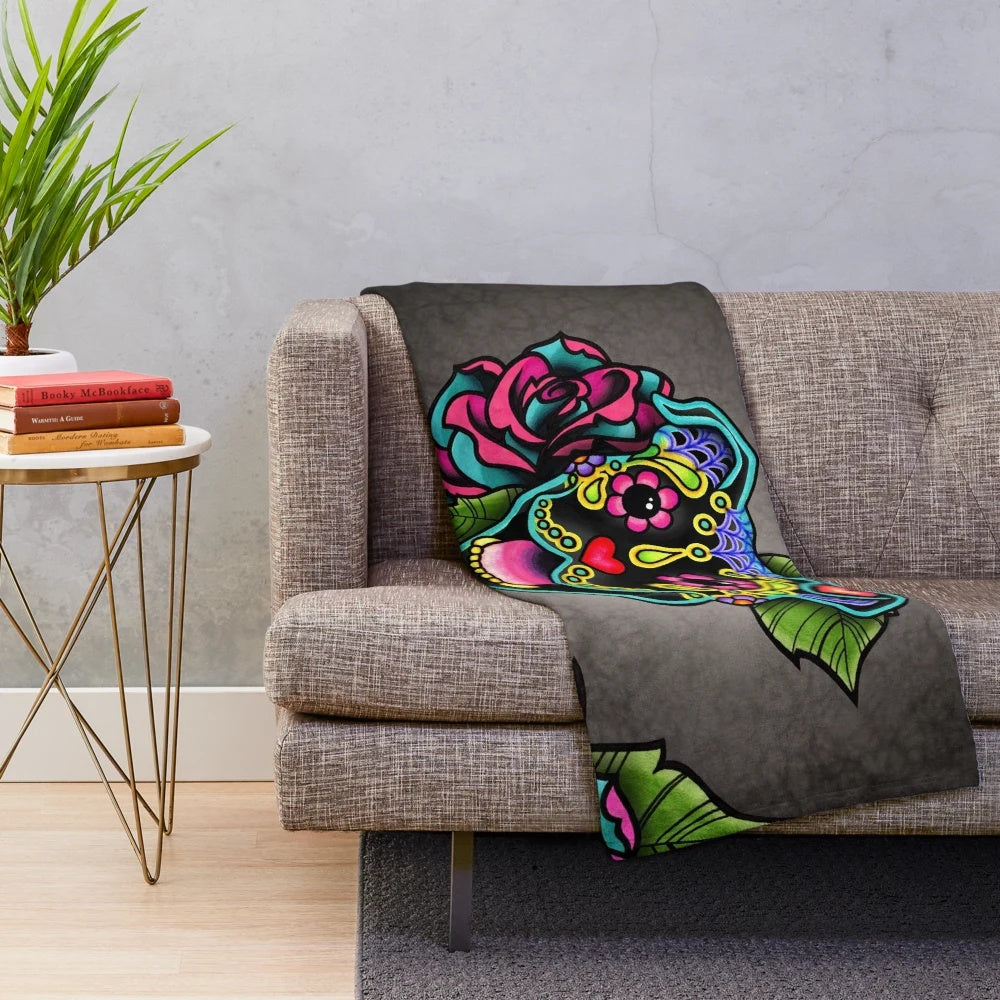 Smiling pit bull with sugar skull design on a plush blanket