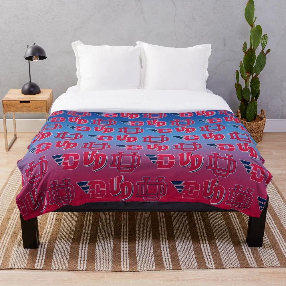 University of Dayton Flyers-inspired plush blanket with red, white, and blue gradient pattern
