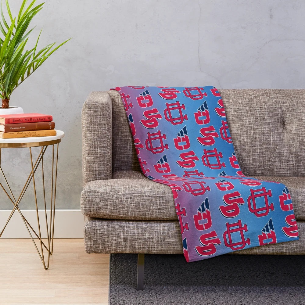 University of Dayton Flyers-inspired plush blanket with red, white, and blue gradient pattern
