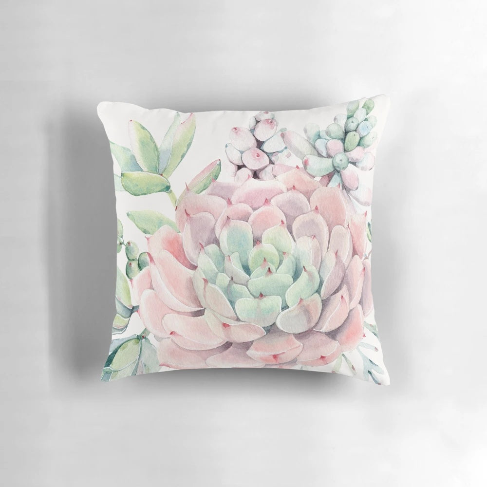 Colorful illustration of pink and green desert succulents on a decorative pillow