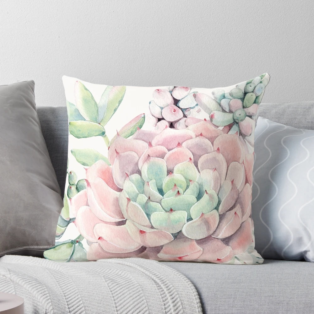 Colorful illustration of pink and green desert succulents on a decorative pillow