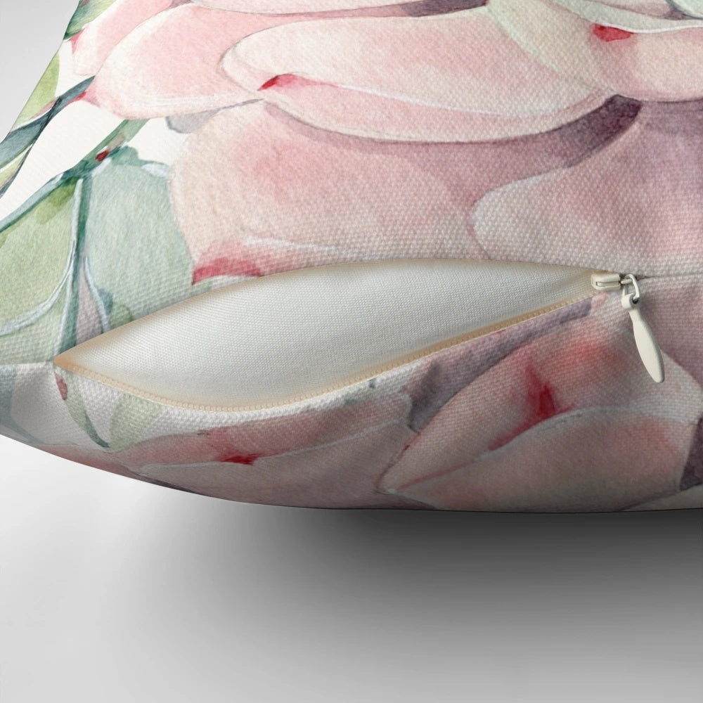 Colorful illustration of pink and green desert succulents on a decorative pillow