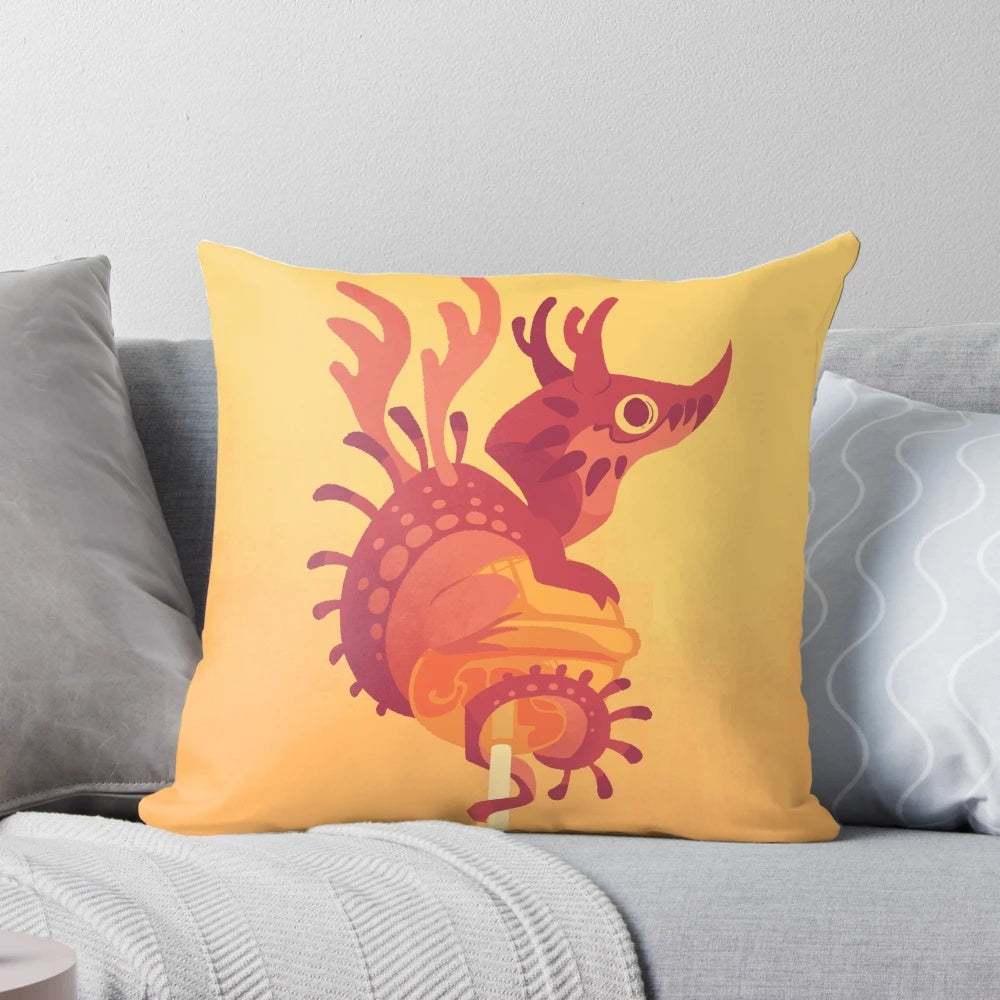 Colorful decorative pillow featuring a whimsical dragon alebrije design in shades of cherry and orange