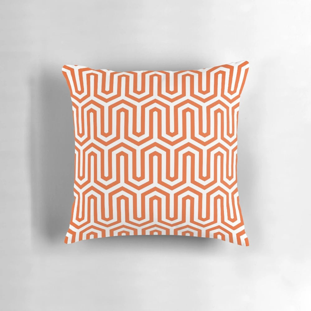 Coral orange pillow with an elegant Egyptian-inspired geometric pattern, perfect for 1920s and 1930s inspired home decor.