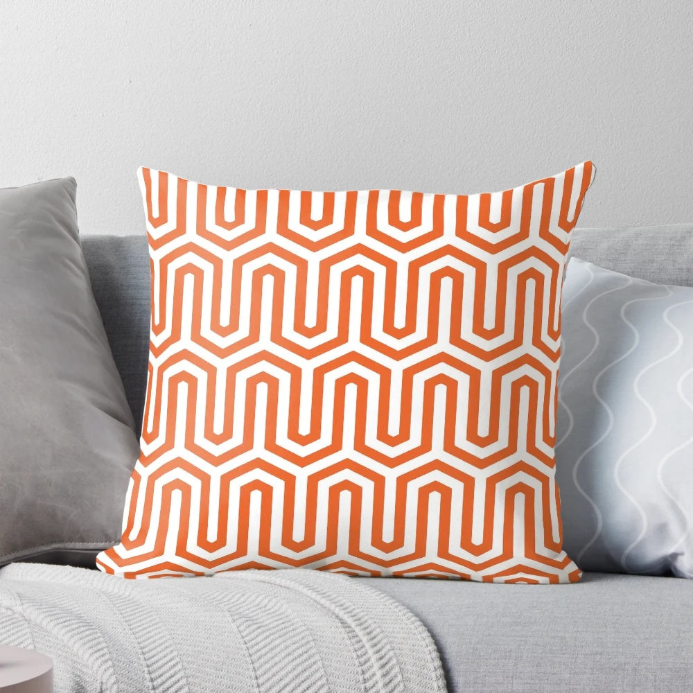 Coral orange pillow with an elegant Egyptian-inspired geometric pattern, perfect for 1920s and 1930s inspired home decor.