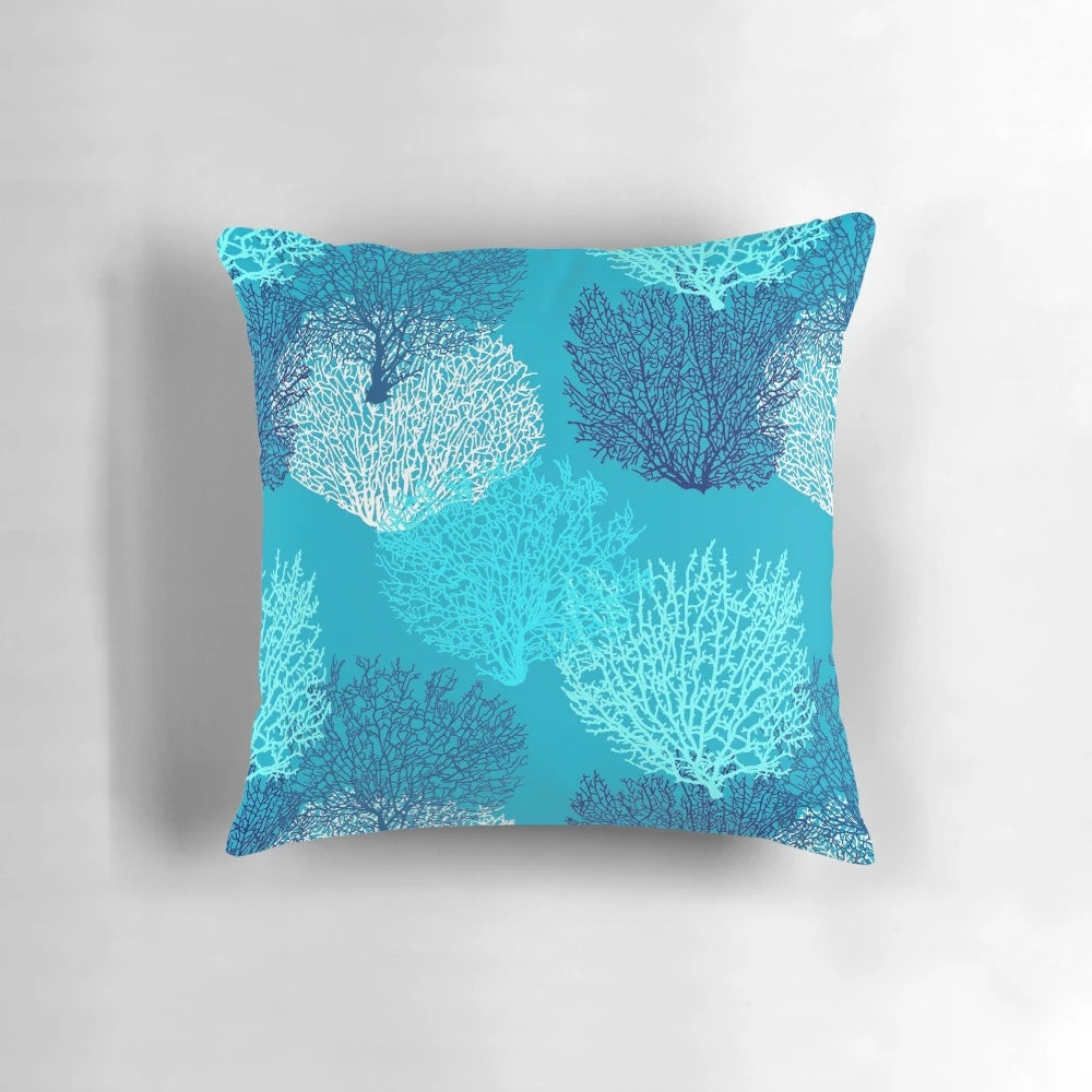Decorative throw pillow featuring a vibrant fan coral print in turquoise, aqua, and cobalt blue shades.