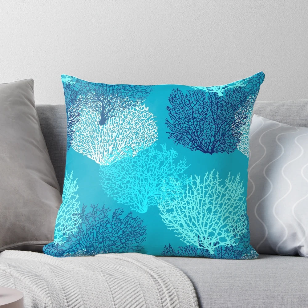 Decorative throw pillow featuring a vibrant fan coral print in turquoise, aqua, and cobalt blue shades.