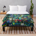 Vibrant, whimsical plush blanket featuring abstract cat designs