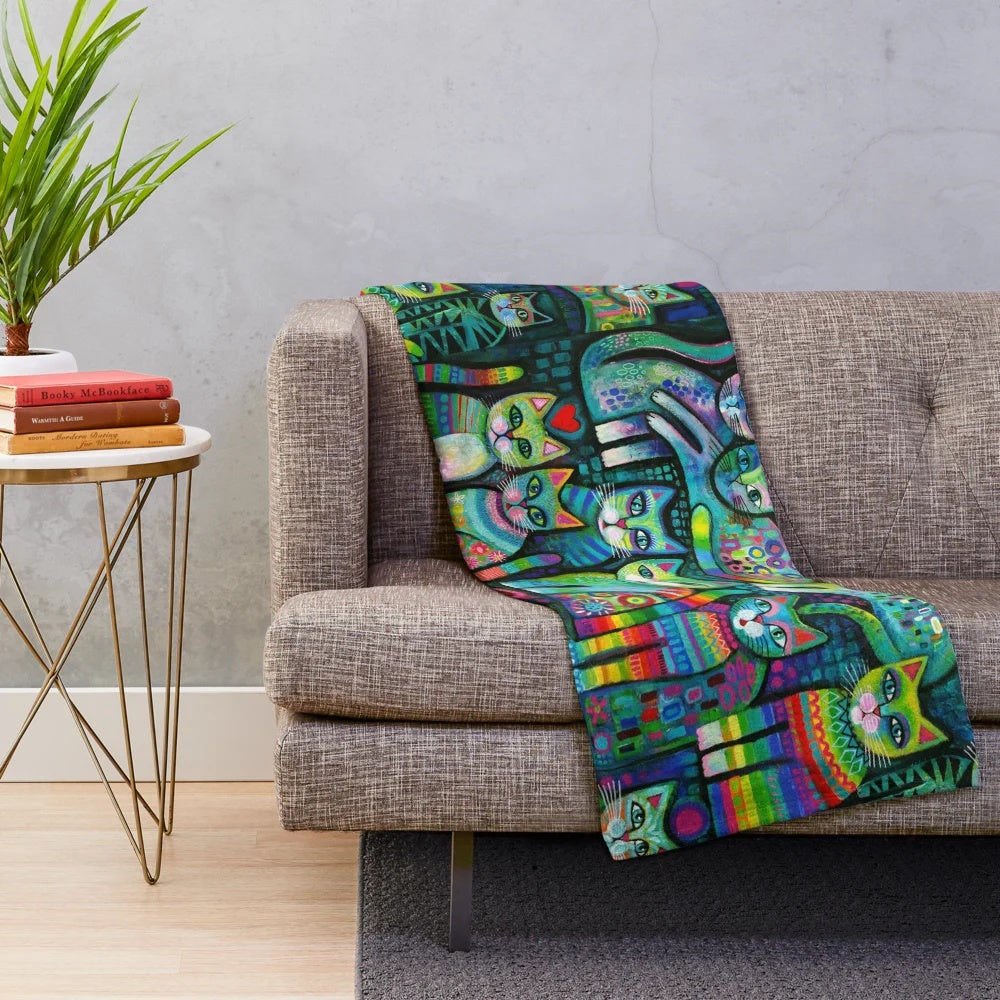 Vibrant, whimsical plush blanket featuring abstract cat designs