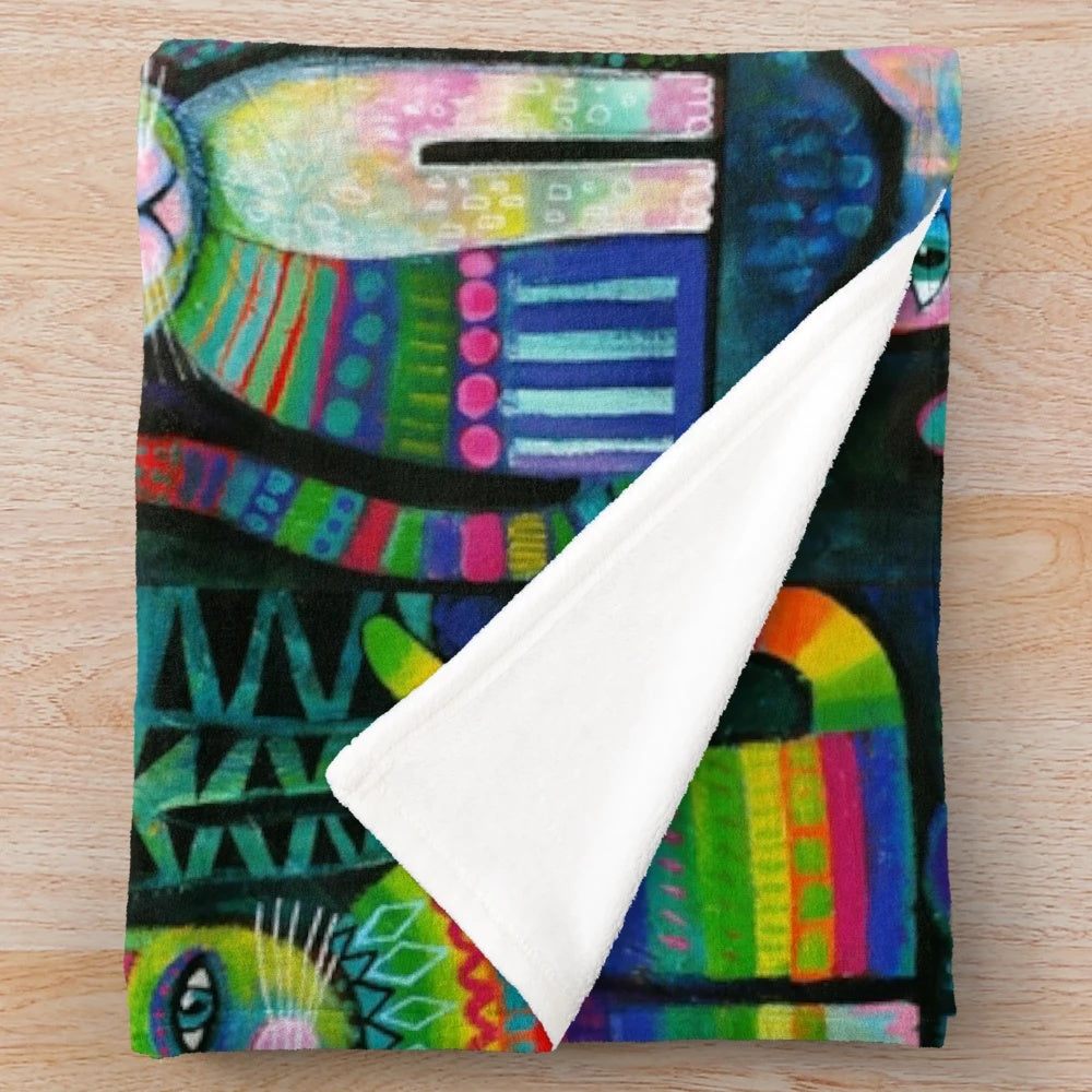 Vibrant, whimsical plush blanket featuring abstract cat designs