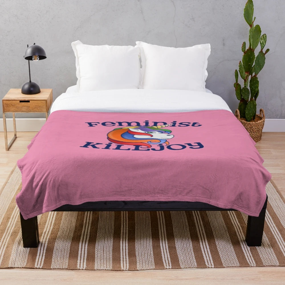 Soft and colorful feminist killjoy plush blanket featuring a rainbow unicorn design