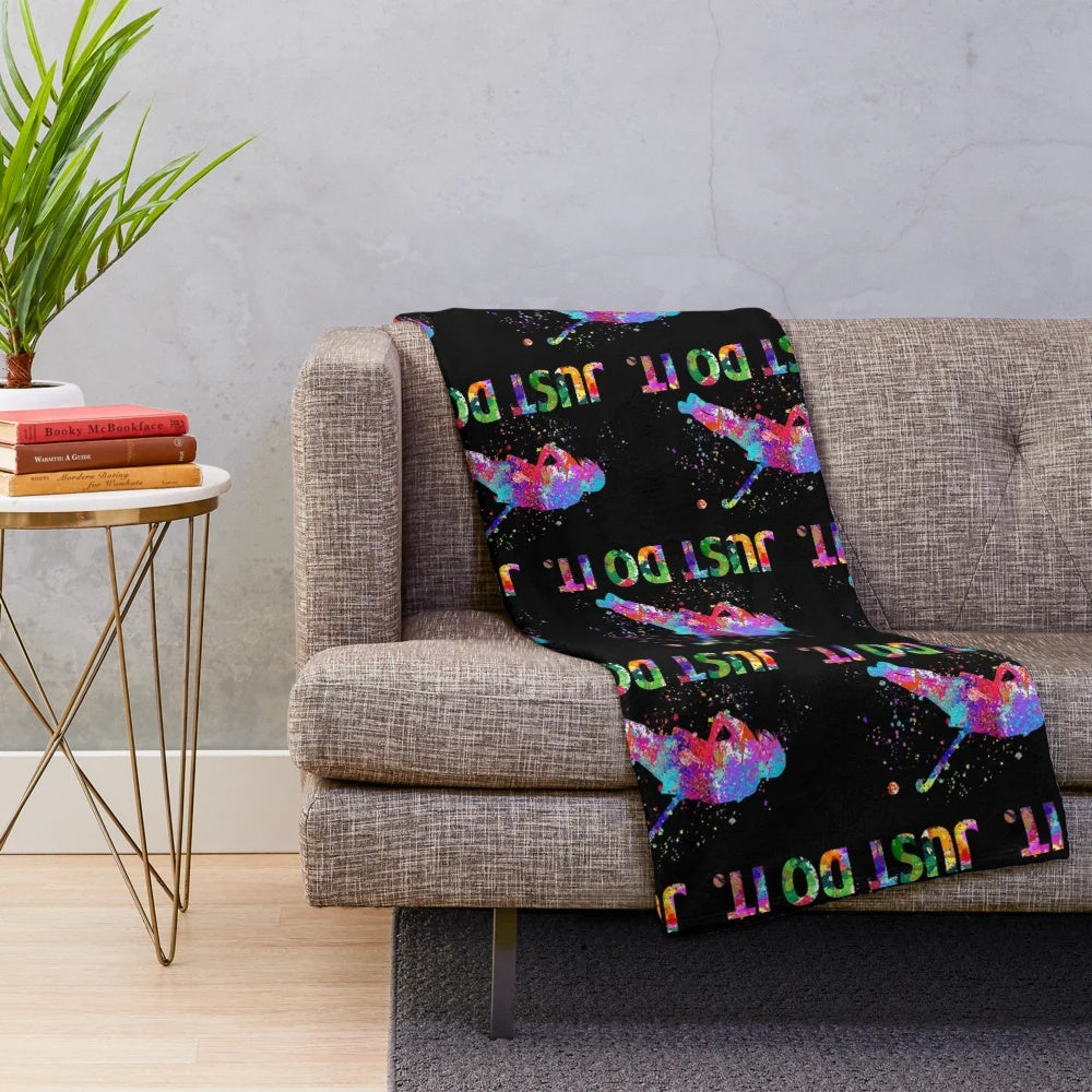 Colorful watercolor field hockey player and equipment on a plush blanket