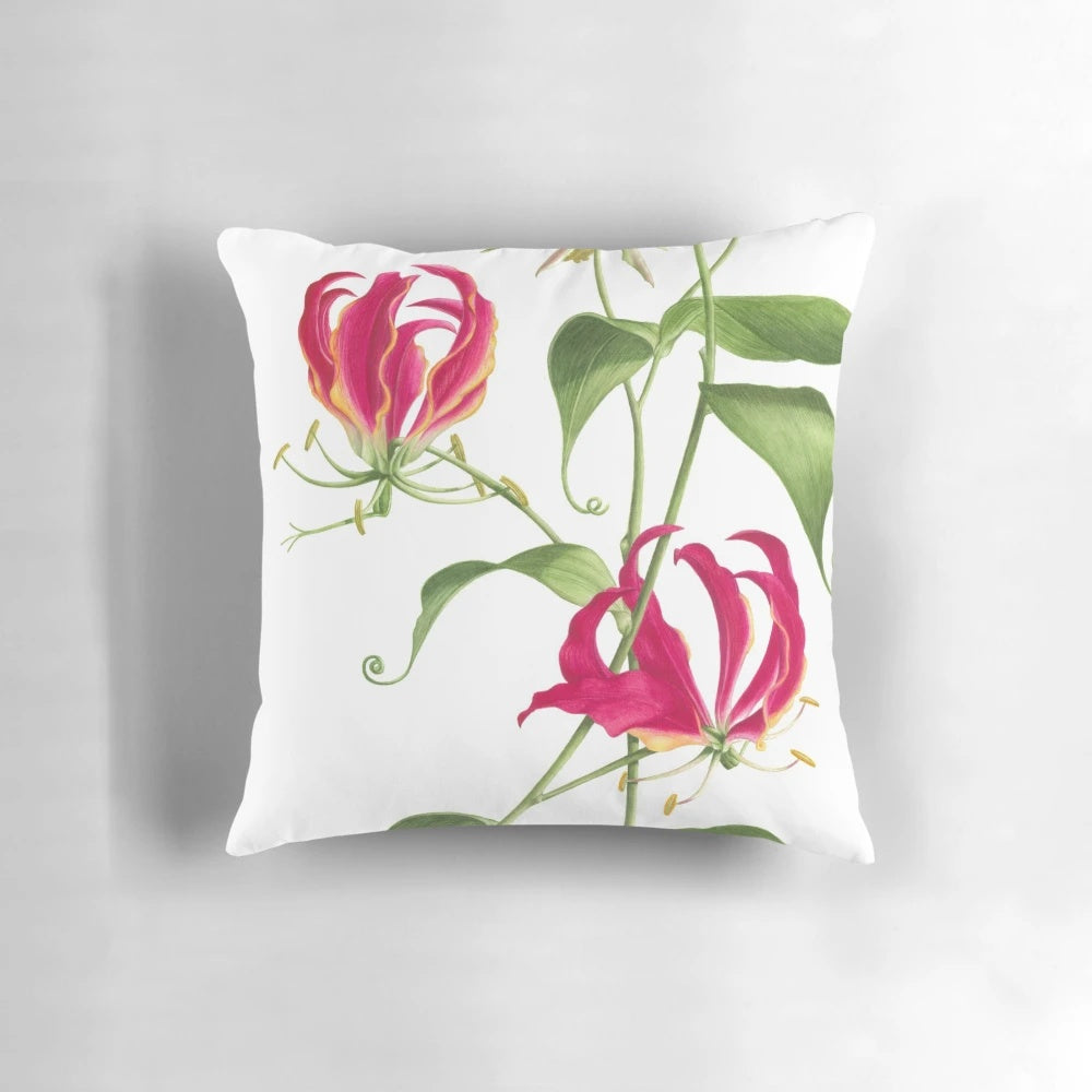 Vibrant watercolor painting of a flame lily flower on a decorative throw pillow