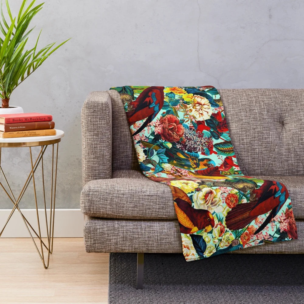 Plush blanket with a vibrant floral and bird pattern