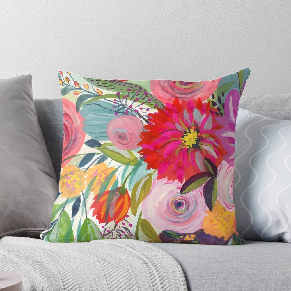 Colorful floral pillow featuring a lush bouquet of pink, purple and green flowers