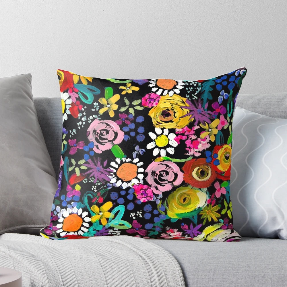 Closeup of a vibrant, colorful floral painting print on a throw pillow.