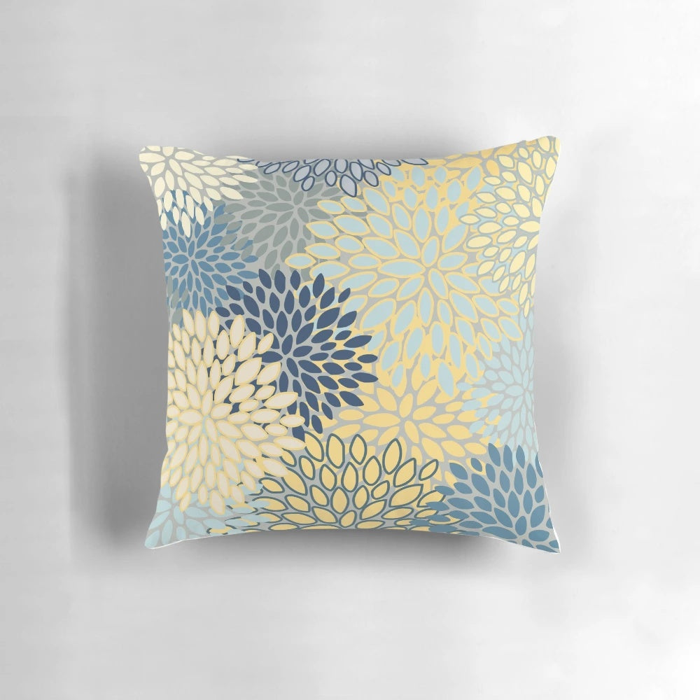 Vibrant floral pattern throw pillow in shades of yellow, gray, blue, and teal