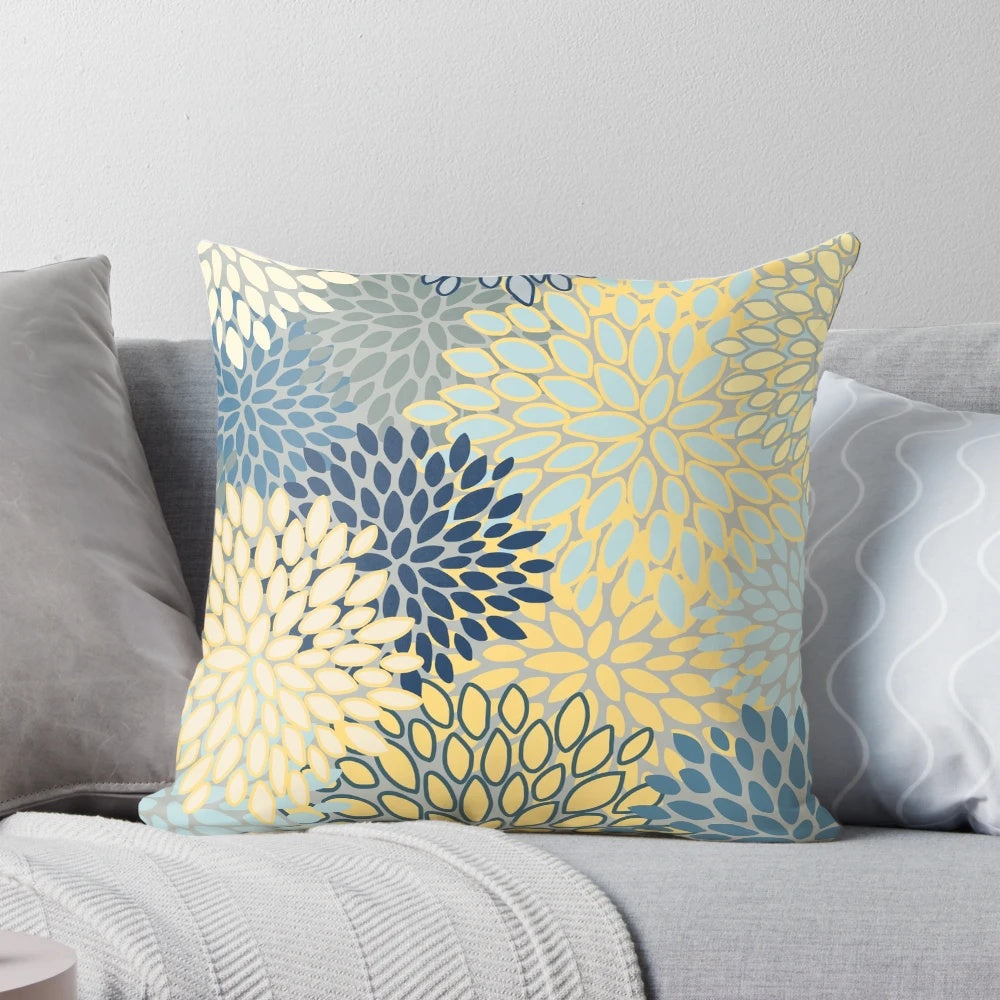 Vibrant floral pattern throw pillow in shades of yellow, gray, blue, and teal