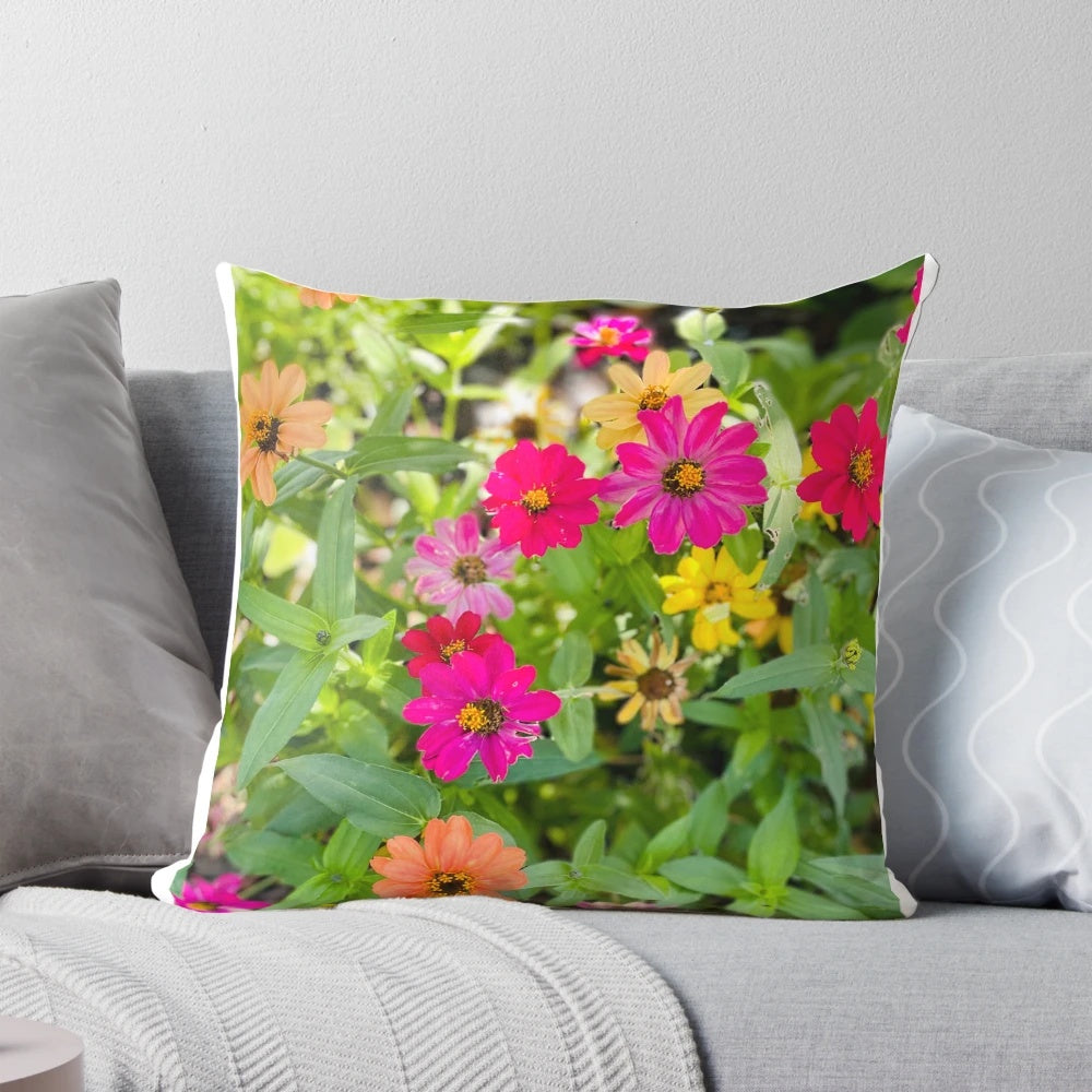 Colorful pillow featuring a bouquet of red, yellow, and pink flowers