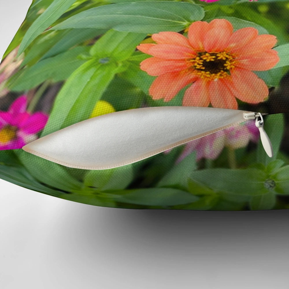 Colorful pillow featuring a bouquet of red, yellow, and pink flowers