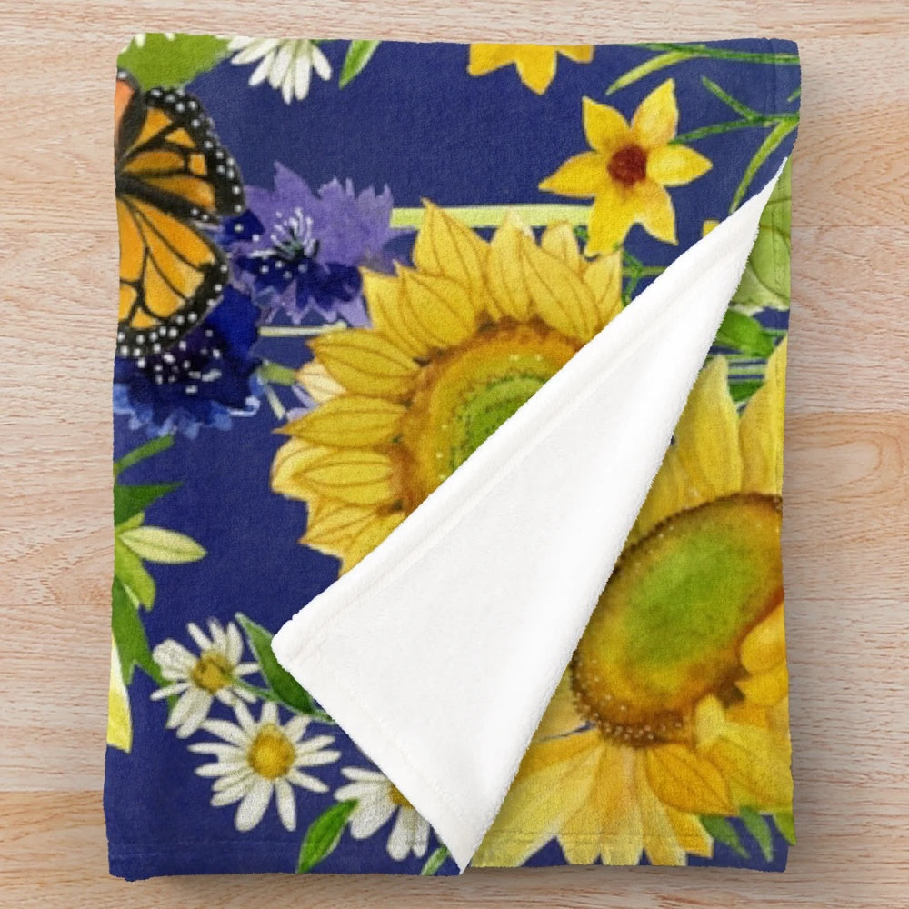 Floral plush blanket with sunflowers and monarch butterflies in a watercolor design