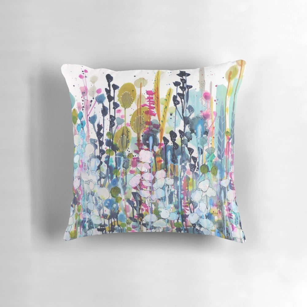 Colorful watercolor-style floral print on a decorative throw pillow