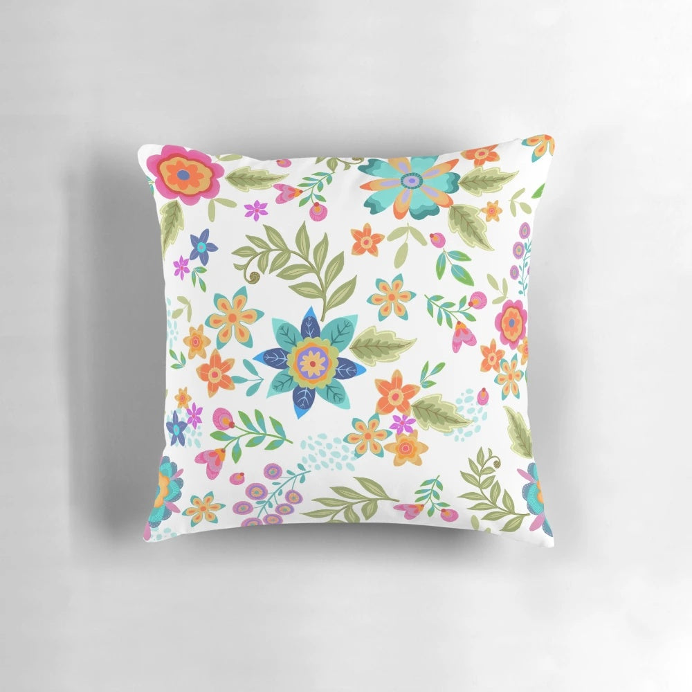 Colorful floral patterned pillow with turquoise, orange, and blue accents