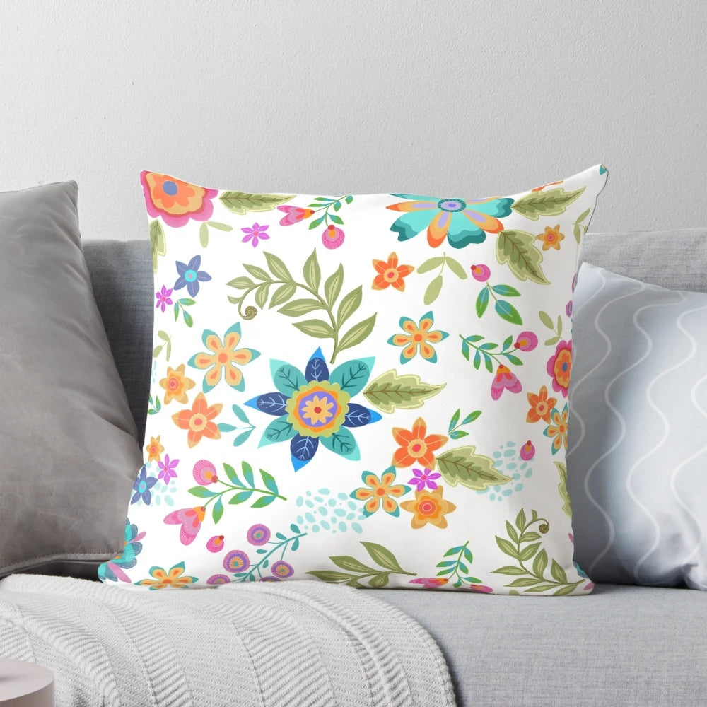 Colorful floral patterned pillow with turquoise, orange, and blue accents