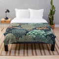 Vibrant forest animals and deer floral print on a blue and green plush blanket