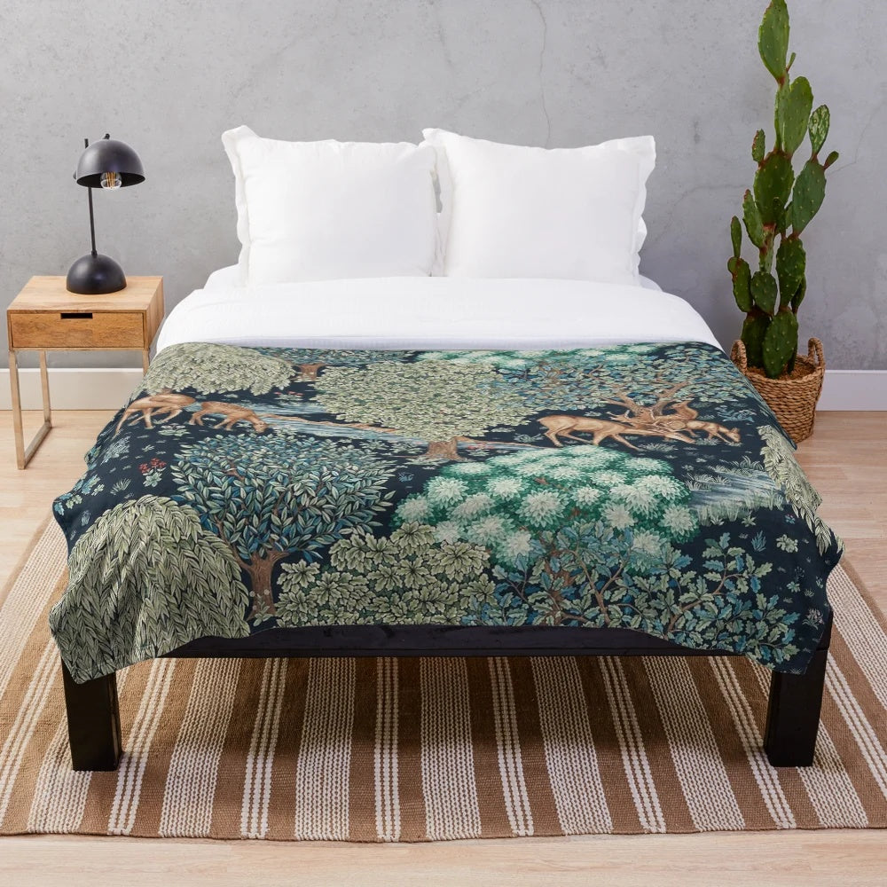 Vibrant forest animals and deer floral print on a blue and green plush blanket