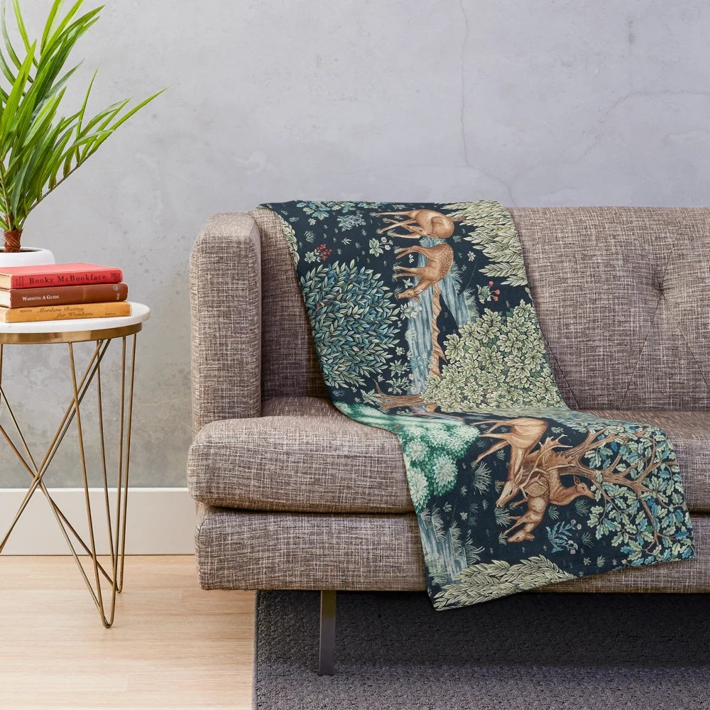 Vibrant forest animals and deer floral print on a blue and green plush blanket