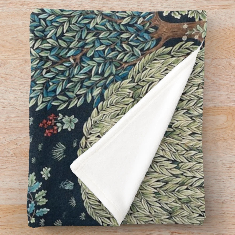 Vibrant forest animals and deer floral print on a blue and green plush blanket