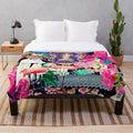 Colorful plush blanket featuring a collage-style design inspired by the artwork of Mexican artist Frida Kahlo