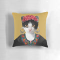 Colorful floral pillow featuring a portrait of Frida Kahlo with a black cat, highlighting the artist's feminist and feline-inspired artwork.