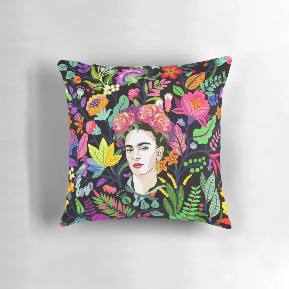 Colorful floral pillow featuring a Frida Kahlo-inspired design with tropical flowers and a dark background.