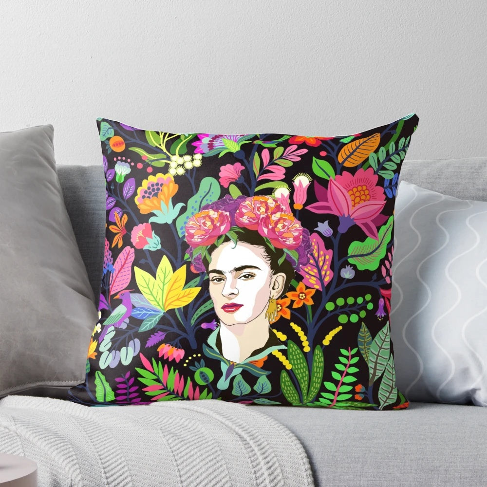 Colorful floral pillow featuring a Frida Kahlo-inspired design with tropical flowers and a dark background.