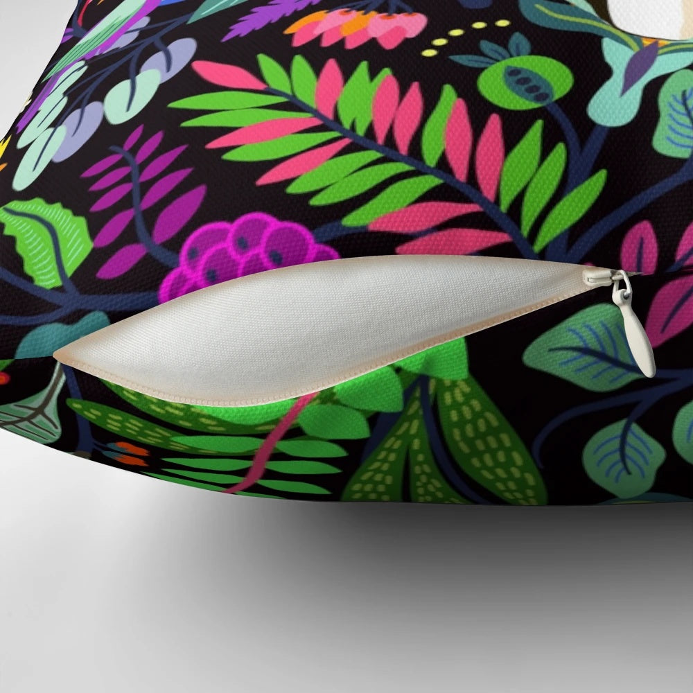 Colorful floral pillow featuring a Frida Kahlo-inspired design with tropical flowers and a dark background.