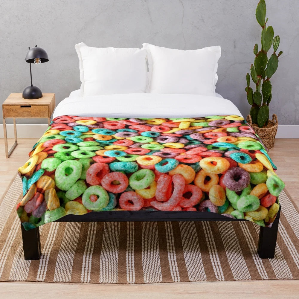 Colorful plush blanket featuring a playful fruit cereal pattern
