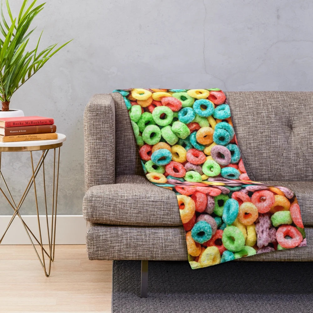 Colorful plush blanket featuring a playful fruit cereal pattern