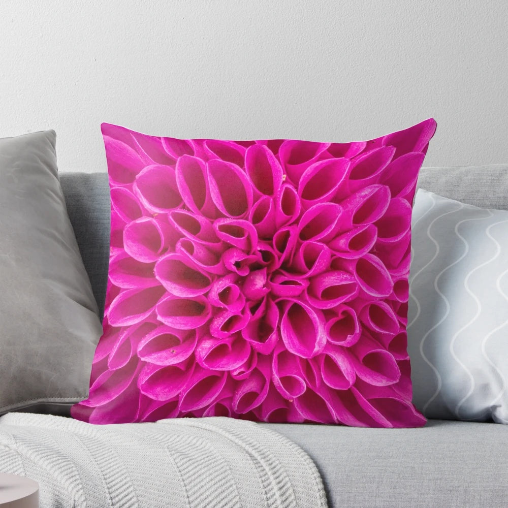 Closeup image of a fuchsia pink flower decorative pillow