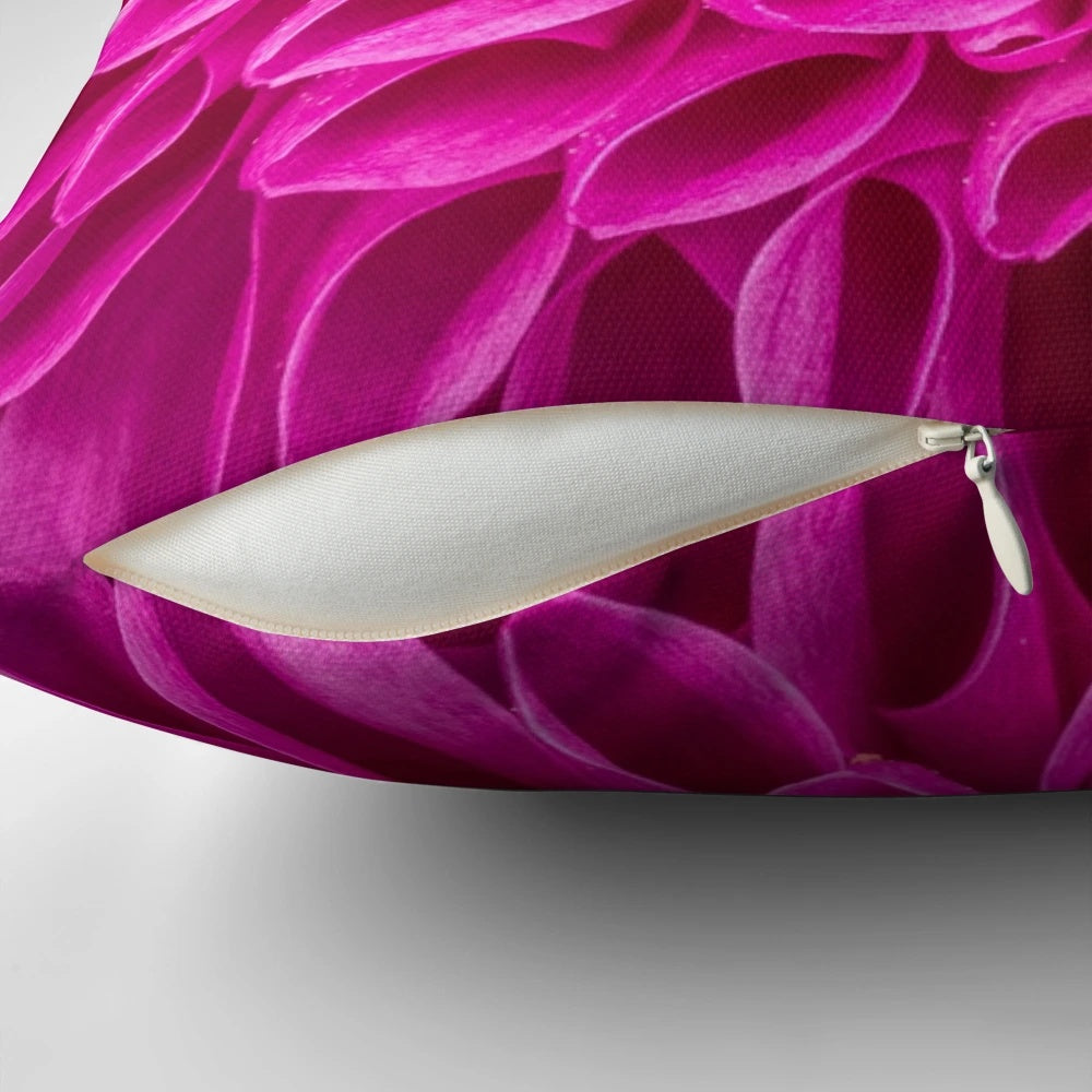 Closeup image of a fuchsia pink flower decorative pillow