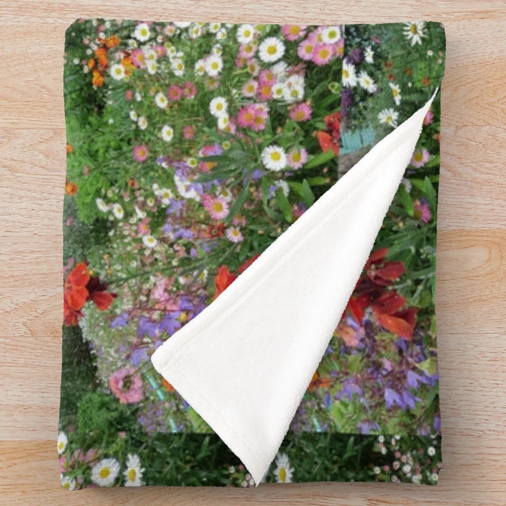 Colorful plush blanket featuring a garden scene with flowers