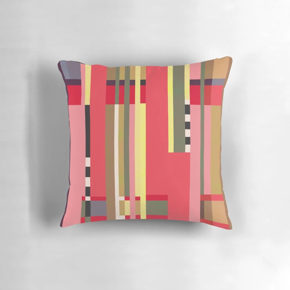 Geometric patterned throw pillow in bright orange, red, and white inspired by Bauhaus design