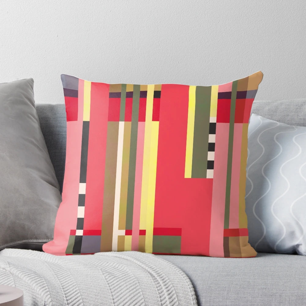 Geometric patterned throw pillow in bright orange, red, and white inspired by Bauhaus design