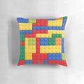 Colorful pillow featuring a geometric building block design in blue, red, yellow, and green