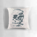 Monochromatic graphic skull print on a cozy throw pillow with a bold, geometric pattern design.
